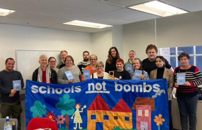 Members of the NSWTF Special interest groups hold a banner.