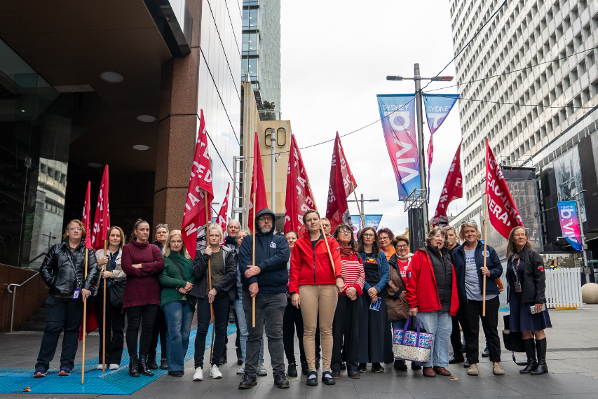 A group of NSW Teachers Federation members with flags in hand went to Martin Place to oppose the threat to workers compensation.