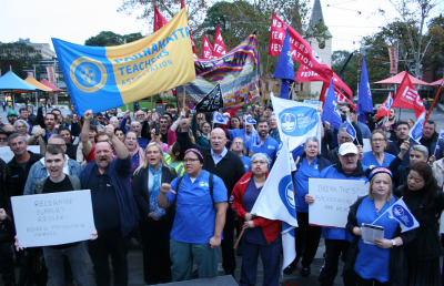 Dozens of people protest in a rally in Parramatta to oppose the threat to workers compensation for mental health injuries.