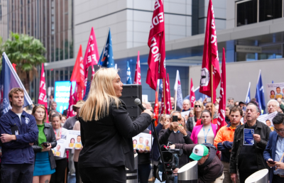 Amber Flohm, Deputy President of the NSW Teachers Federation, speeches during a rally in Sydney for workers compensation.