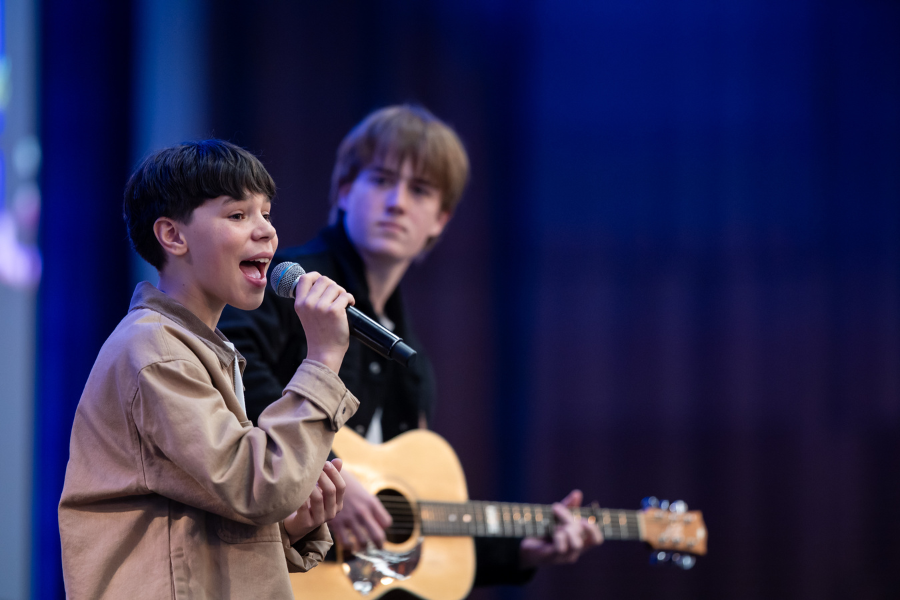 Students perform a musical number at the opening of day two of the NSWTF Annual Conference 2025, in Darling Harbour, Sydney.